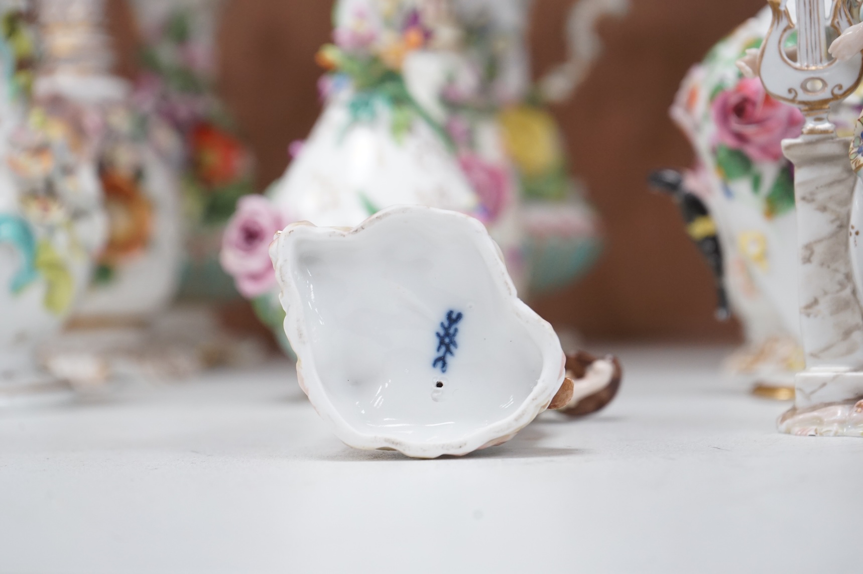 A group of English porcelain flower encrusted scent bottles and yours, Coalport, Minton etc., c.1830-50 together with Continental porcelain figures a wall pocket etc, largest 26cm high